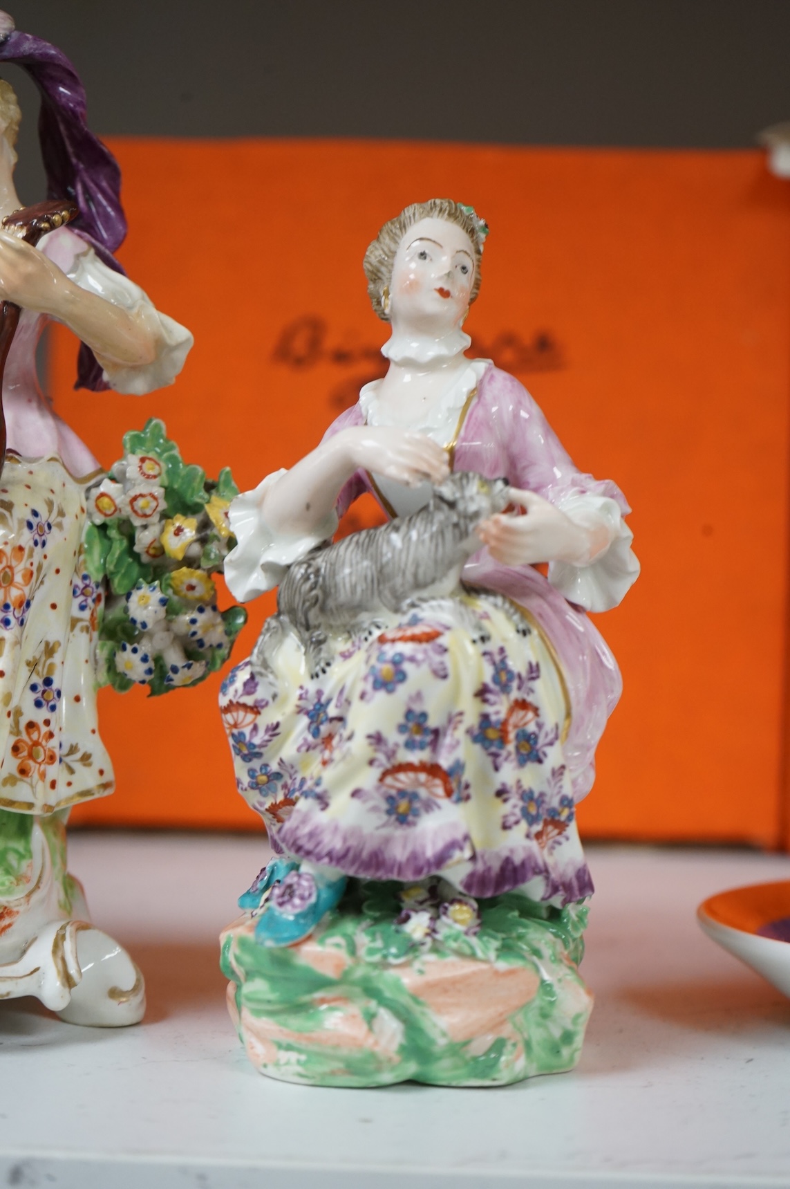 A pair of Derby porcelain figures of musicians, and another of a lady and cat, late 18th century, largest 18cm high